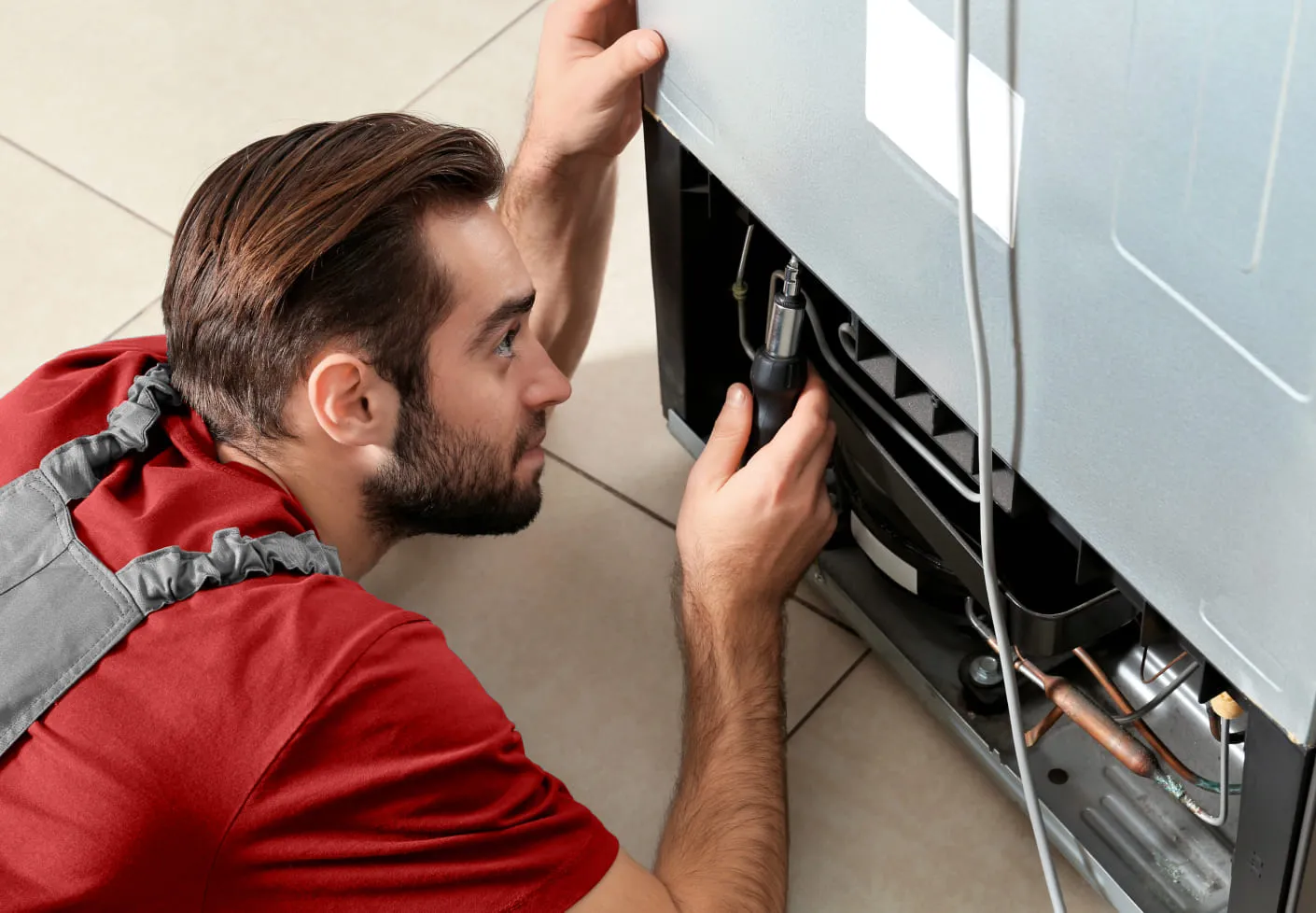 Photo of refrigerator repair with a repairman